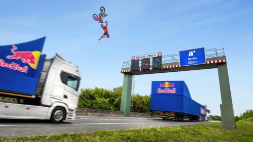 Motorbike Backflip Between Two Moving Trucks (world first)